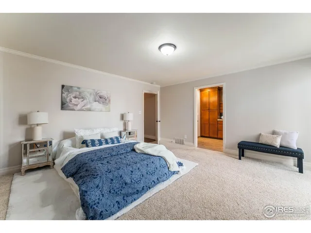 a spacious bedroom with a bed a couch and a window