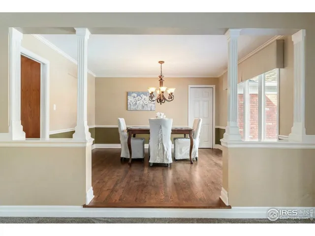 a living room with furniture wooden floor and a chandelier