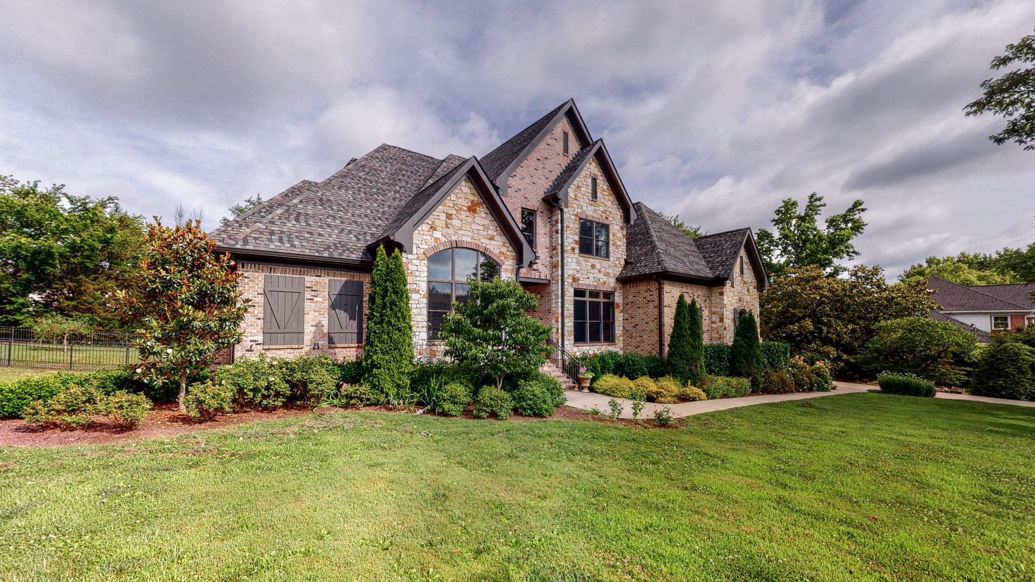1110 Ridgeway Drive Franklin, TN 37067 - Photo 2 of 48 a front view of a house with a yard and potted plants