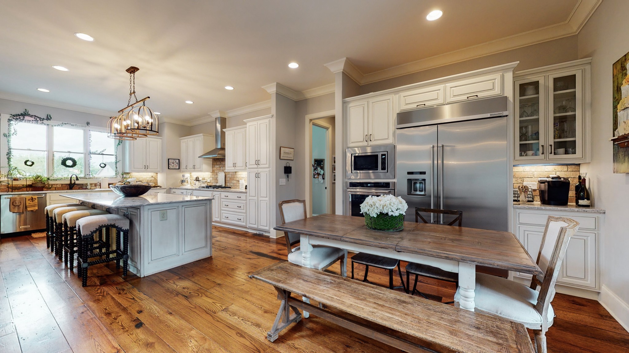1110 Ridgeway Drive Franklin, TN 37067 - Photo 8 of 48 a kitchen with stainless steel appliances granite countertop a dining table chairs and wooden floor