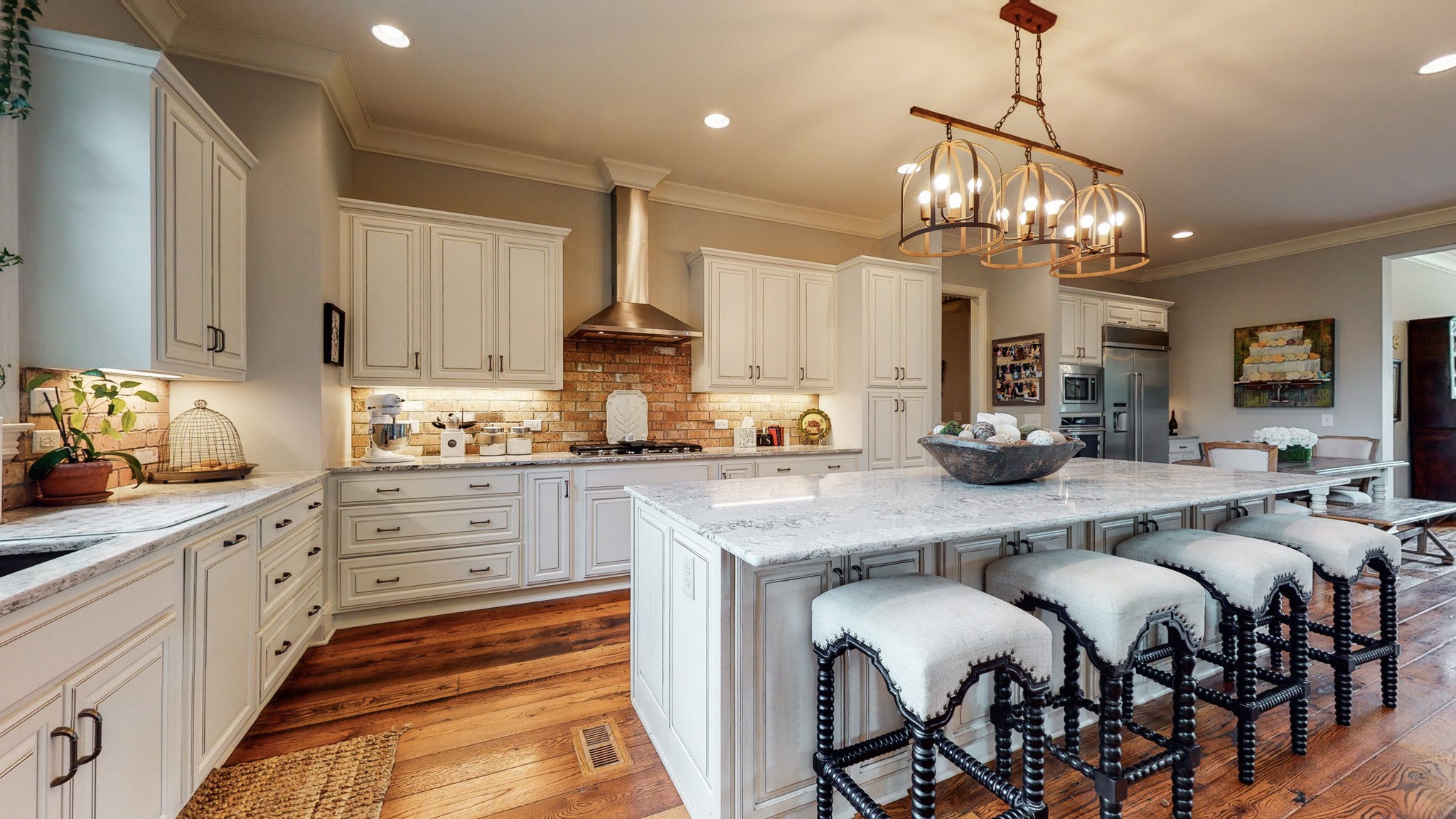 1110 Ridgeway Drive Franklin, TN 37067 - Photo 10 of 48 a large kitchen with granite countertop a white table chairs and a wooden floor