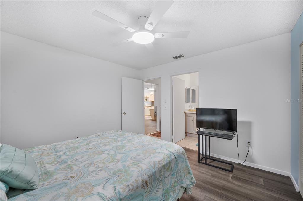 205 Winter Ridge Boulevard Winter Haven, FL 33881 - Photo 11 of 36 a bedroom with a bed and a flat screen tv