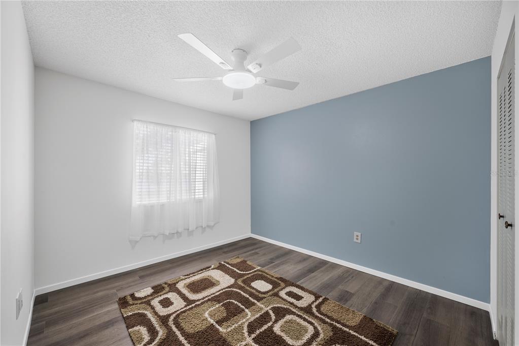 205 Winter Ridge Boulevard Winter Haven, FL 33881 - Photo 16 of 36 an empty room with wooden floor and windows