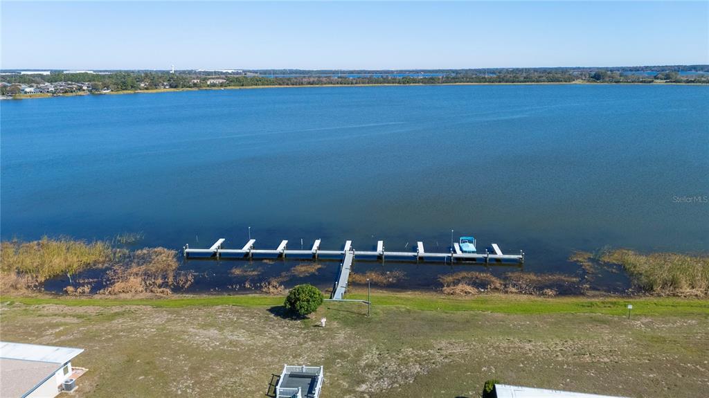 205 Winter Ridge Boulevard Winter Haven, FL 33881 - Photo 34 of 36 a view of a lake with couches in the back yard