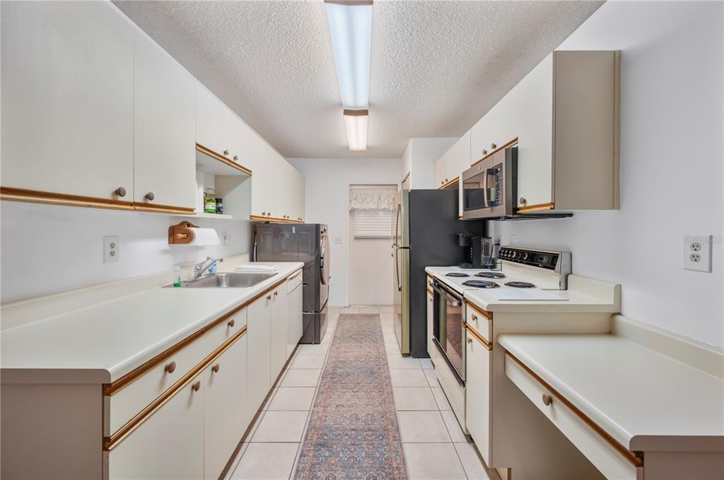 205 Winter Ridge Boulevard Winter Haven, FL 33881 - Photo 7 of 36 a kitchen with a stove sink and cabinets
