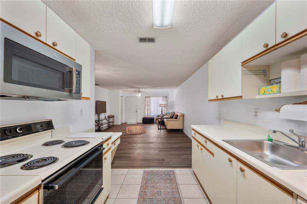 205 Winter Ridge Boulevard Winter Haven, FL 33881 - Photo 9 of 36 a kitchen with a stove and a sink