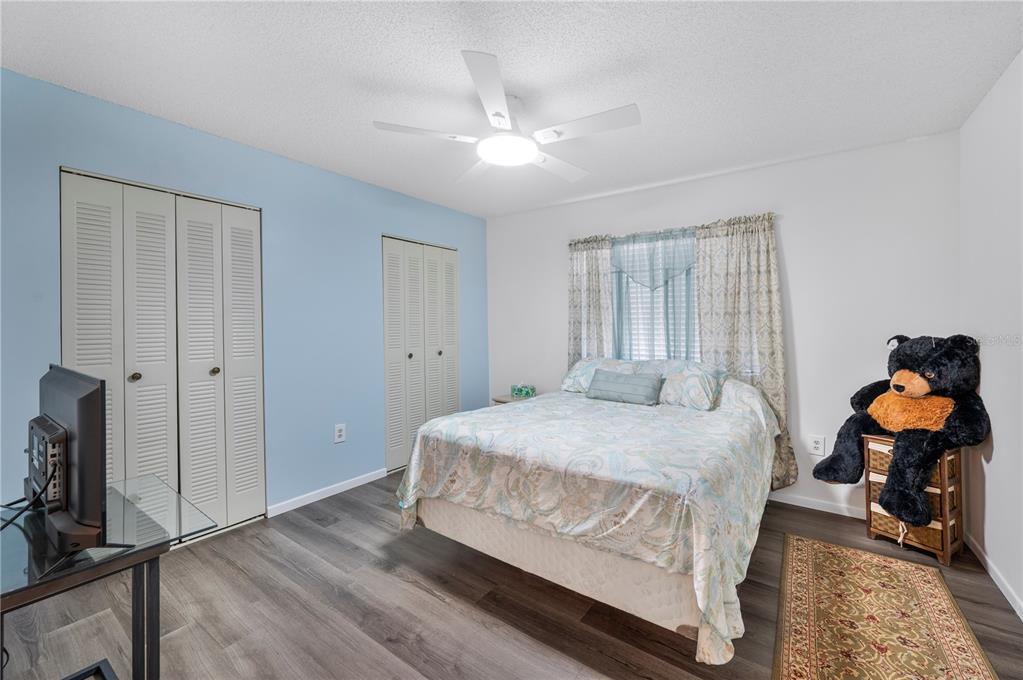 205 Winter Ridge Boulevard Winter Haven, FL 33881 - Photo 10 of 36 a bedroom with a bed and a chandelier