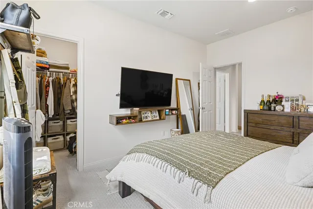 a bedroom with a bed and a television