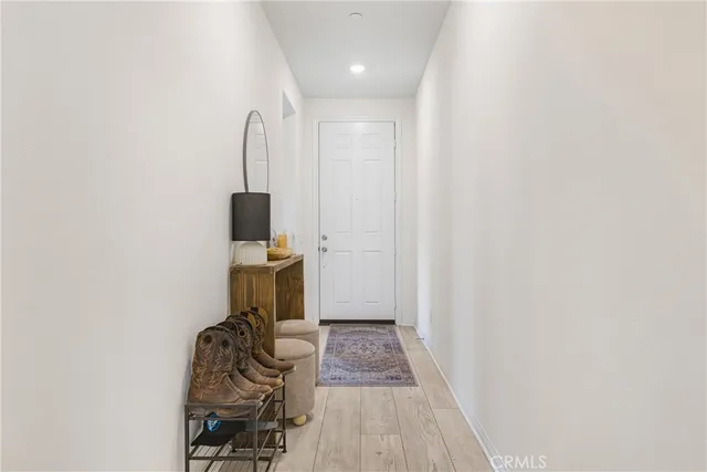a view of a room with wooden floor and white walls