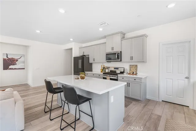 a kitchen with appliances a sink cabinets and a counter top space