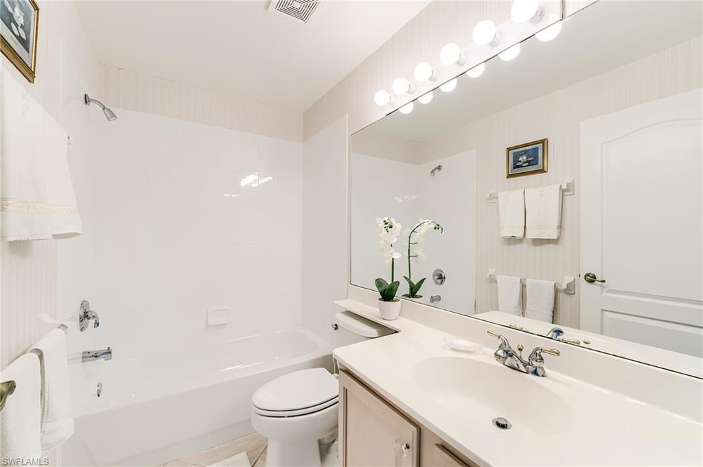 9156 Spring Run Boulevard Estero, FL 34135 - Photo 18 of 34 a bathroom with a sink a toilet and shower