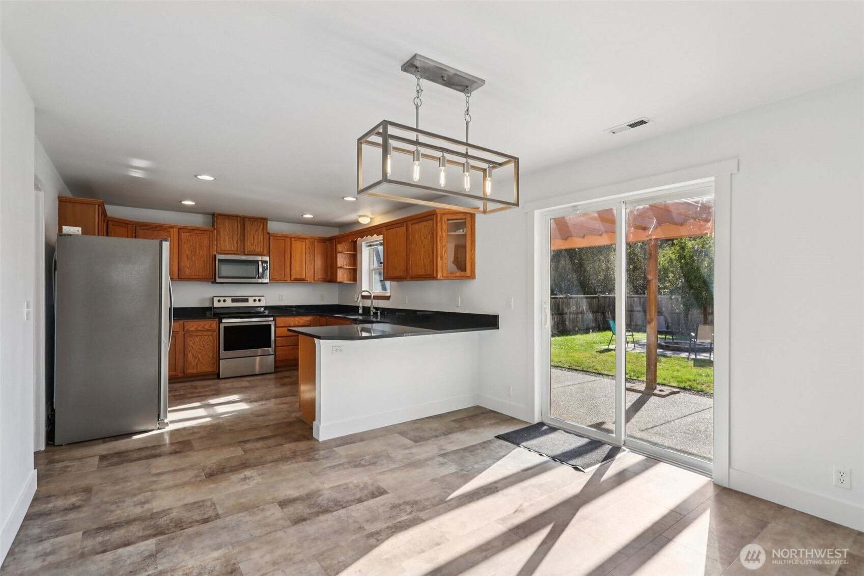 114 Weaver Street Northeast Orting, WA 98360 - Photo 12 of 40 a view of kitchen with refrigerator stove and wooden floor