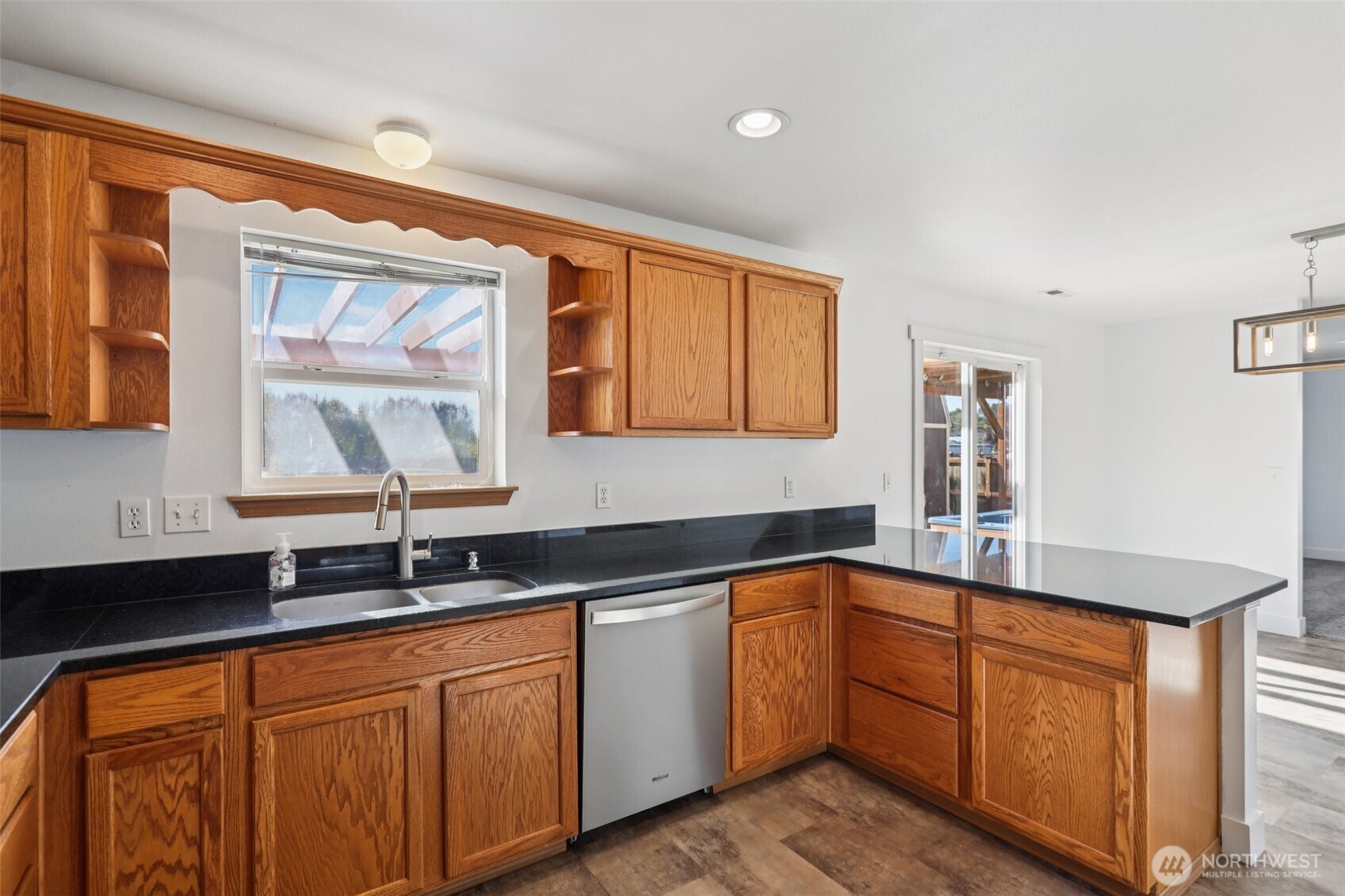 114 Weaver Street Northeast Orting, WA 98360 - Photo 14 of 40 a kitchen with stainless steel appliances granite countertop white cabinets sink and window