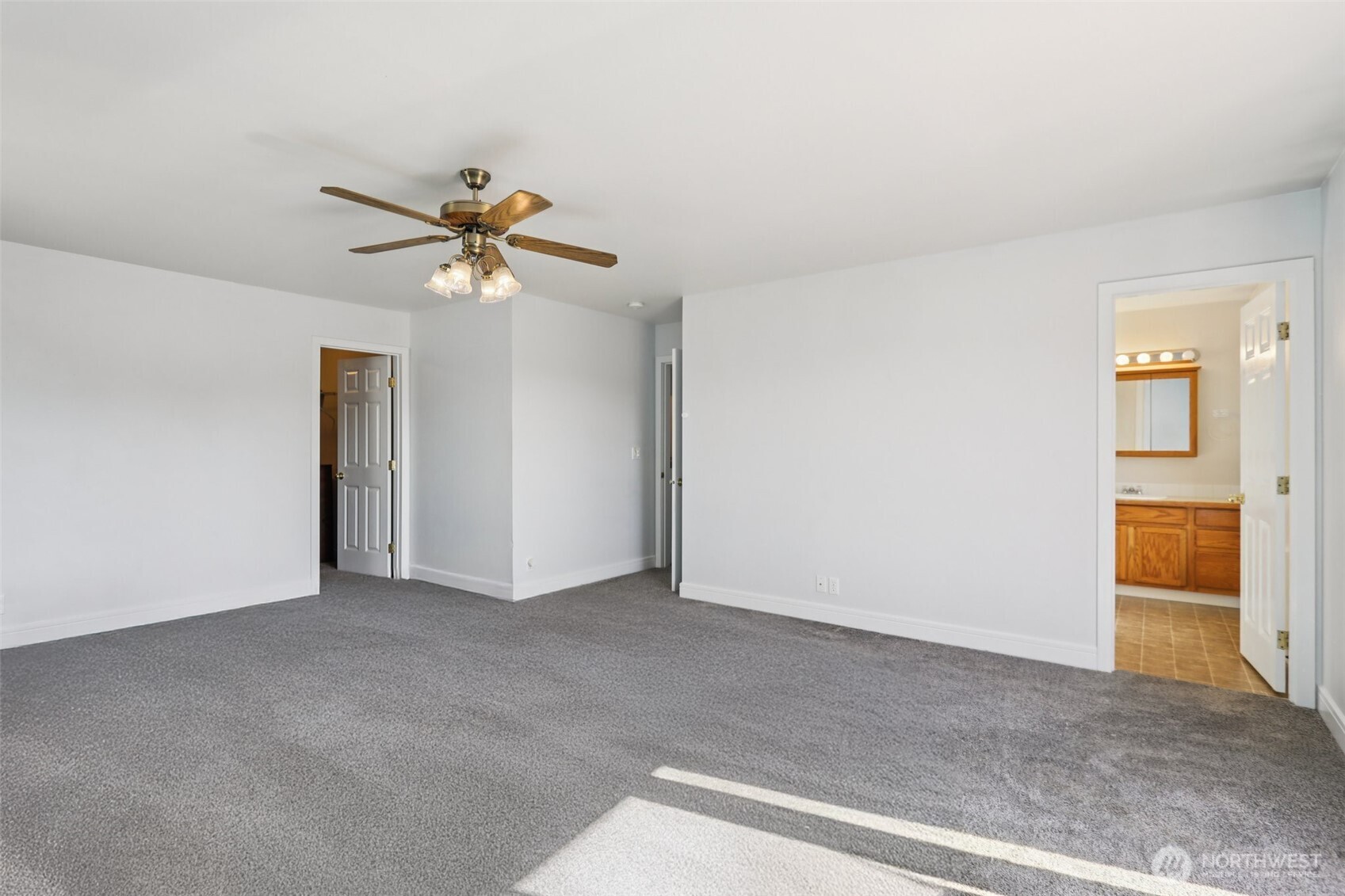 114 Weaver Street Northeast Orting, WA 98360 - Photo 22 of 40 an empty room with closet and a chandelier fan