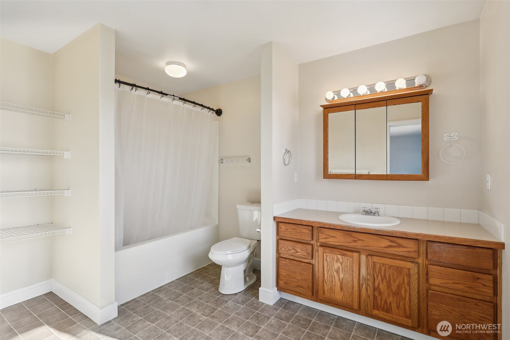114 Weaver Street Northeast Orting, WA 98360 - Photo 23 of 40 a spacious bathroom with a granite countertop sink toilet and shower