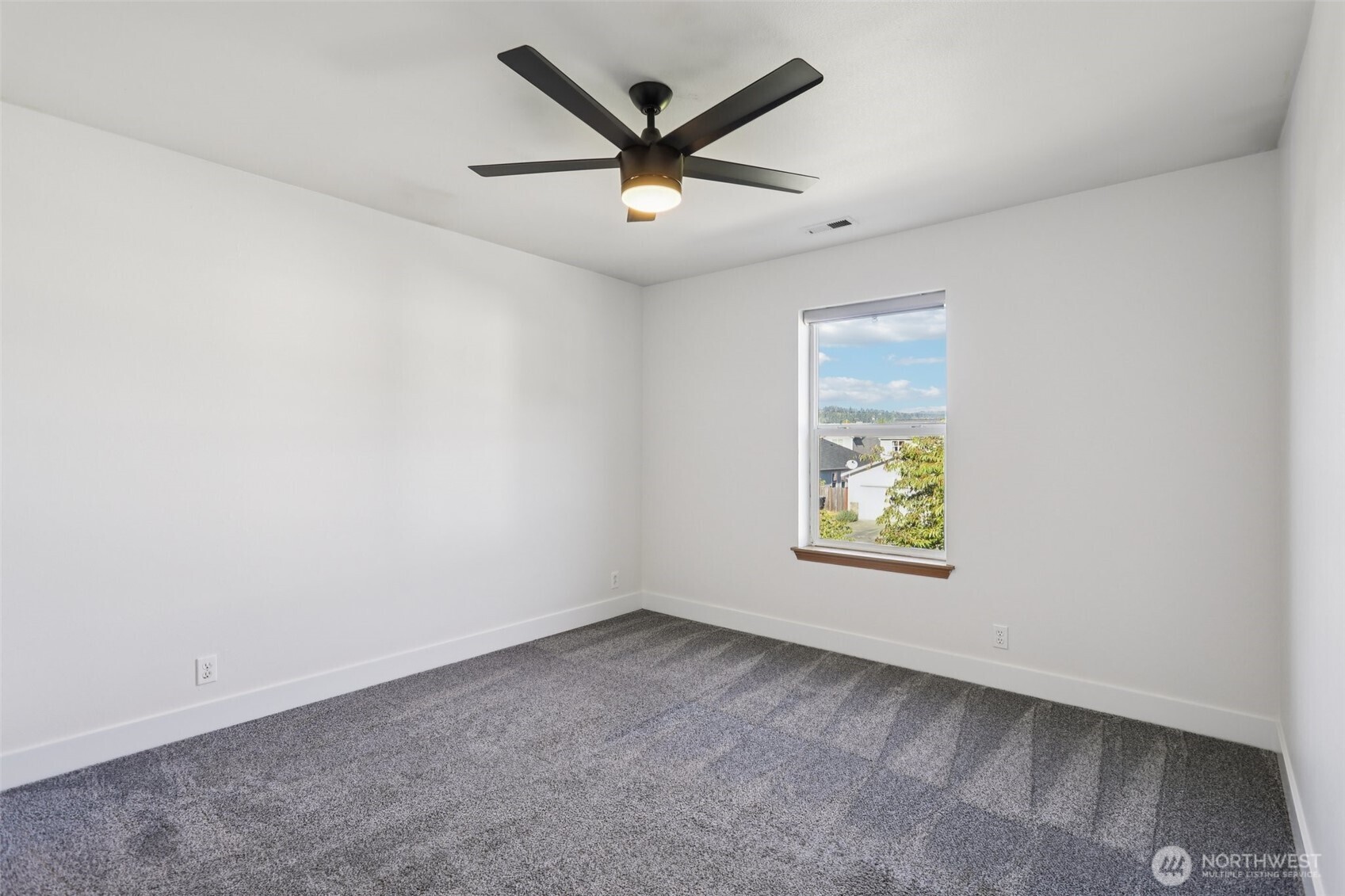 114 Weaver Street Northeast Orting, WA 98360 - Photo 29 of 40 an empty room with window and a ceiling fan