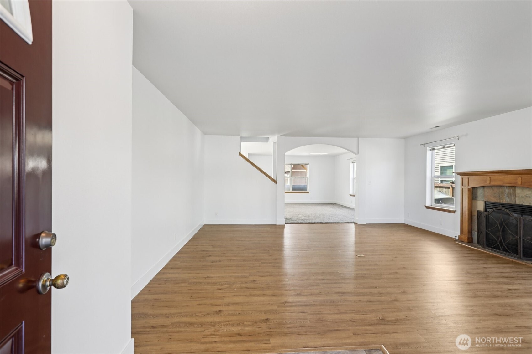 114 Weaver Street Northeast Orting, WA 98360 - Photo 3 of 40 a view of empty room with wooden floor and fireplace