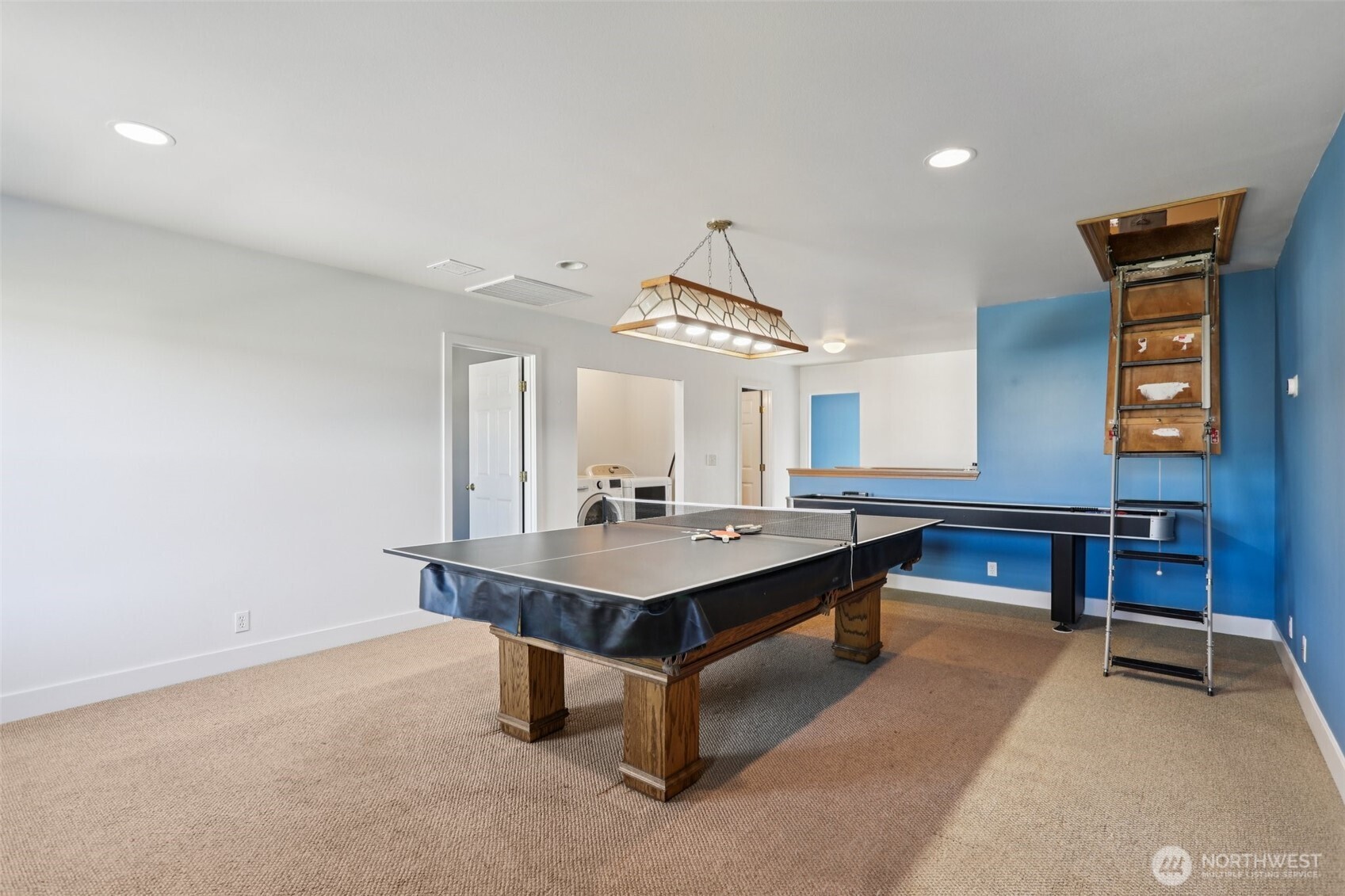 114 Weaver Street Northeast Orting, WA 98360 - Photo 31 of 40 a view of a room with shelves and wooden floor