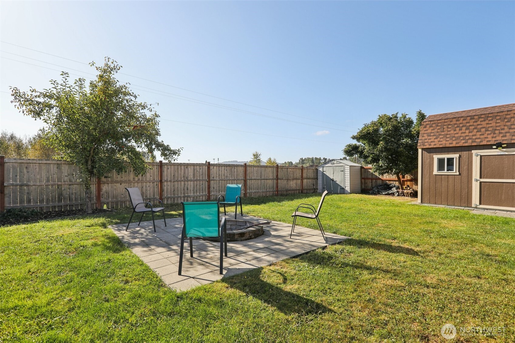 114 Weaver Street Northeast Orting, WA 98360 - Photo 38 of 40 a view of backyard with a patio and a garden