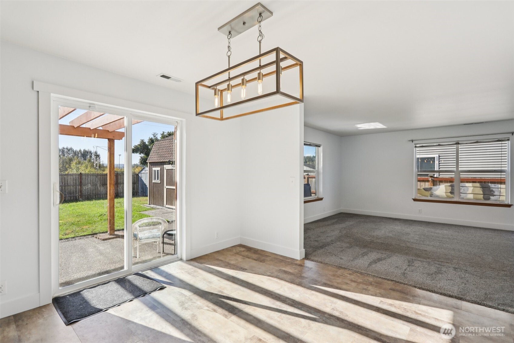 114 Weaver Street Northeast Orting, WA 98360 - Photo 10 of 40 a view of a livingroom with wooden floor and a ceiling fan