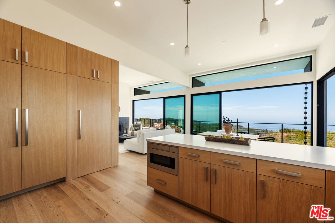 2165 Little Las Flores Road Topanga, CA 90290 - Photo 11 of 40 a large kitchen with a large window and stainless steel appliances