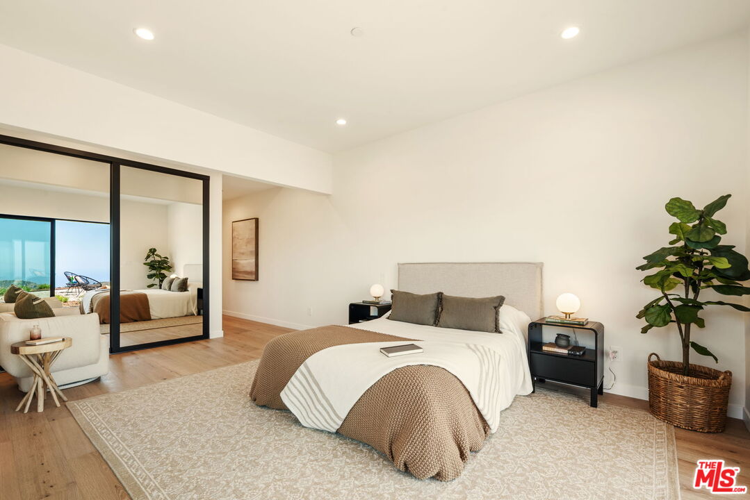 2165 Little Las Flores Road Topanga, CA 90290 - Photo 22 of 40 a bedroom with furniture and a potted plant