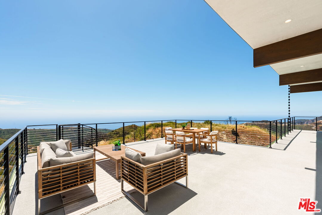 2165 Little Las Flores Road Topanga, CA 90290 - Photo 33 of 40 a balcony with chairs and table