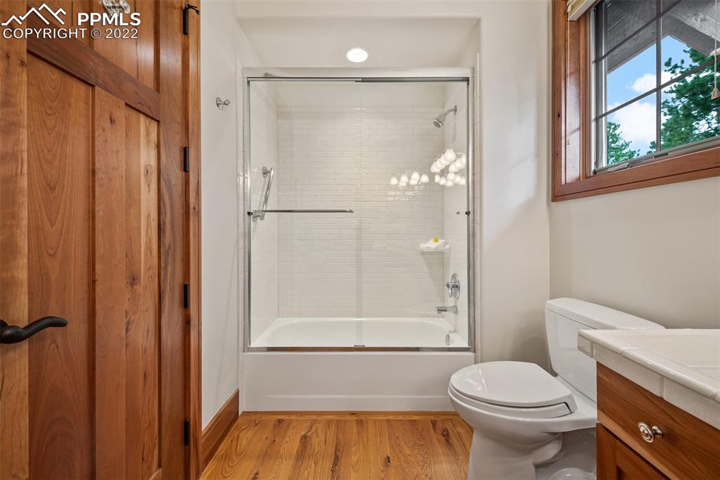 3833 Lorraine Road Larkspur, CO 80118 - Photo 17 of 40 a bathroom with a granite countertop toilet a sink and shower