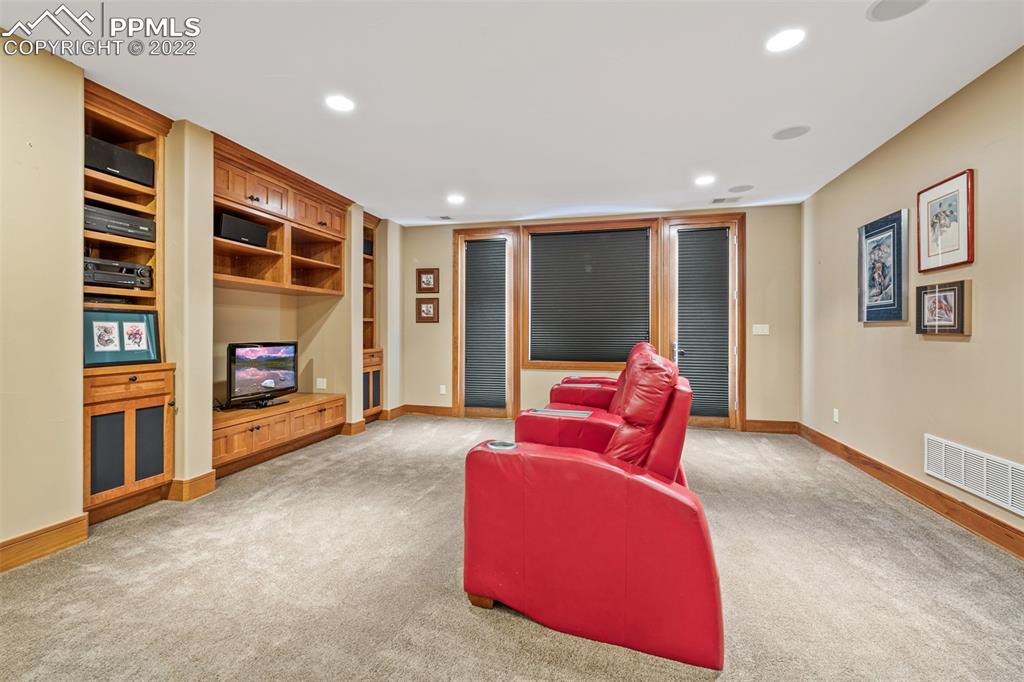 3833 Lorraine Road Larkspur, CO 80118 - Photo 19 of 40 a living room with furniture and a fireplace