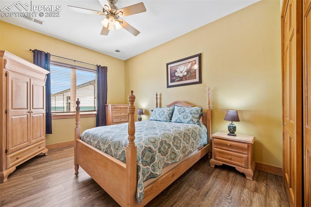 3833 Lorraine Road Larkspur, CO 80118 - Photo 29 of 40 a bedroom with a bed and a chandelier