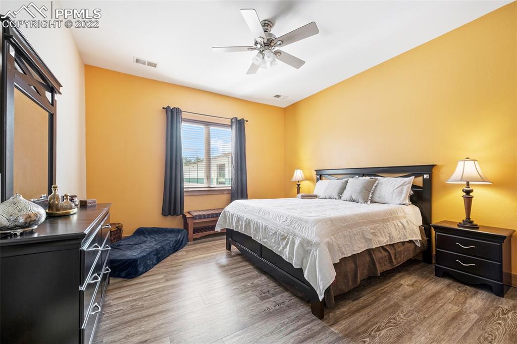 3833 Lorraine Road Larkspur, CO 80118 - Photo 30 of 40 a bedroom with bed and wooden floor