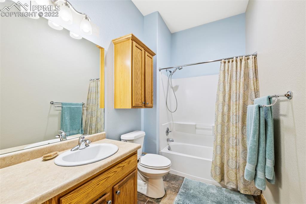 3833 Lorraine Road Larkspur, CO 80118 - Photo 31 of 40 a bathroom with a granite countertop sink toilet and shower