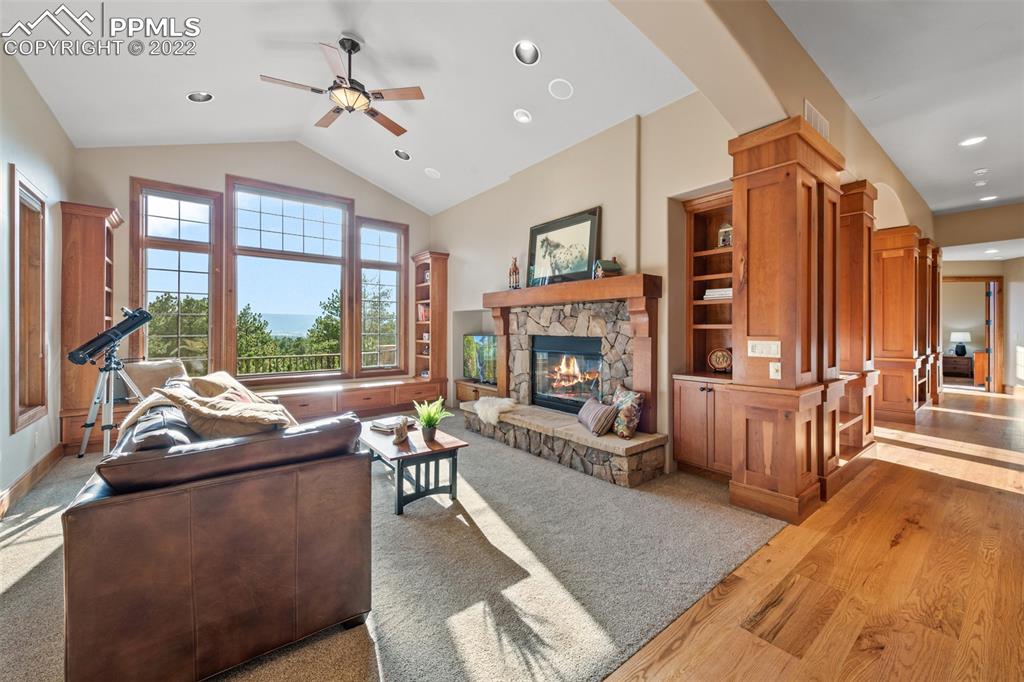 3833 Lorraine Road Larkspur, CO 80118 - Photo 5 of 40 a living room with furniture and a fireplace