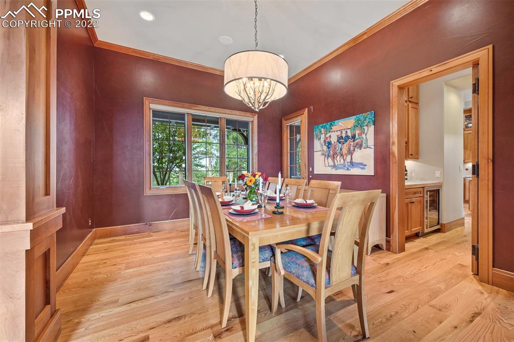 3833 Lorraine Road Larkspur, CO 80118 - Photo 9 of 40 a dining room with furniture a chandelier and wooden floor