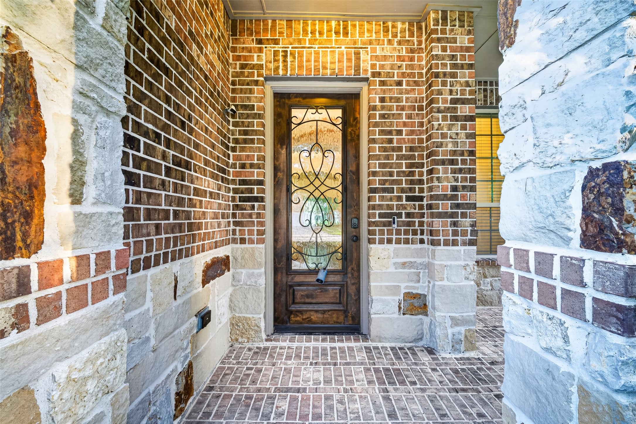 7930 Summer Night Lane Rosenberg, TX 77469 - Photo 5 of 48 Welcoming covered front porch with elegant stone accents and a glass-paneled front entry.