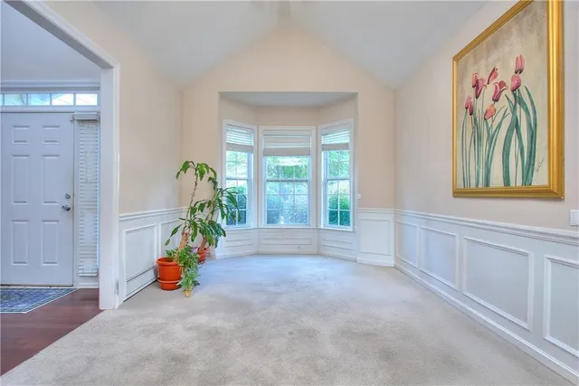 a spacious bathroom with a tub sink and mirror
