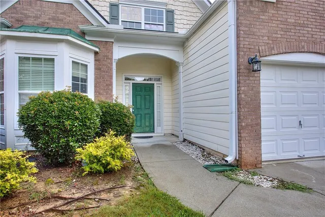 front view of a house with potted plants