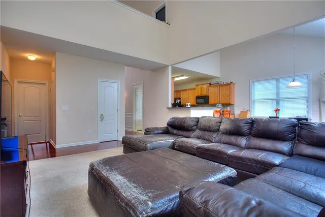 a bathroom with a granite countertop sink a toilet and a shower curtain