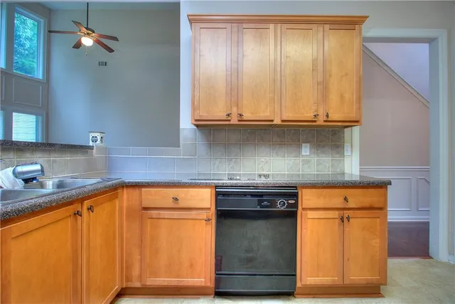 a kitchen with stainless steel appliances granite countertop a sink stove and cabinets