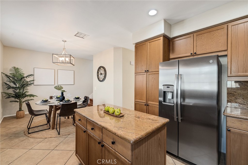 2786 Border Avenue Torrance, CA 90501 - Photo 21 of 47 a kitchen with stainless steel appliances kitchen island granite countertop a table chairs and a refrigerator