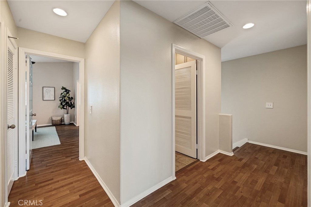 2786 Border Avenue Torrance, CA 90501 - Photo 35 of 47 a view of a hallway with wooden floor and a bedroom