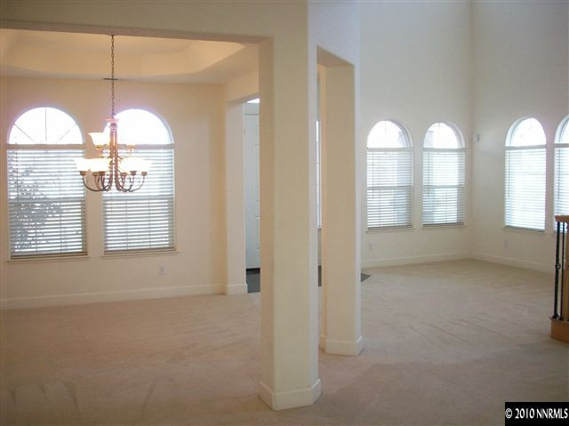 1696 Moquith Court Reno, NV 89521 - Photo 2 of 8 a view of empty room with window and wooden floor