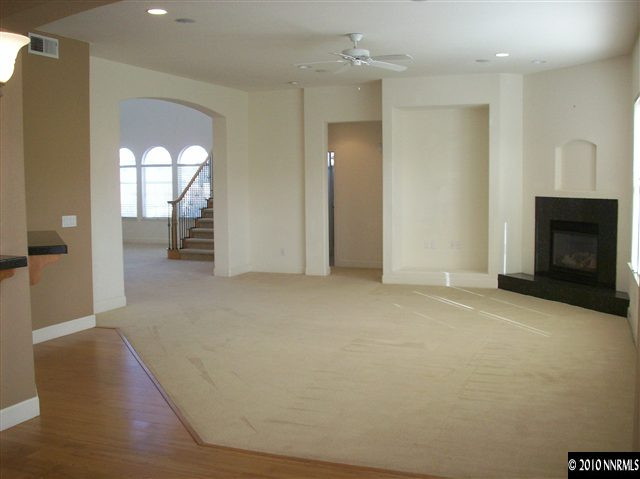 1696 Moquith Court Reno, NV 89521 - Photo 4 of 8 an empty room with windows and fireplace