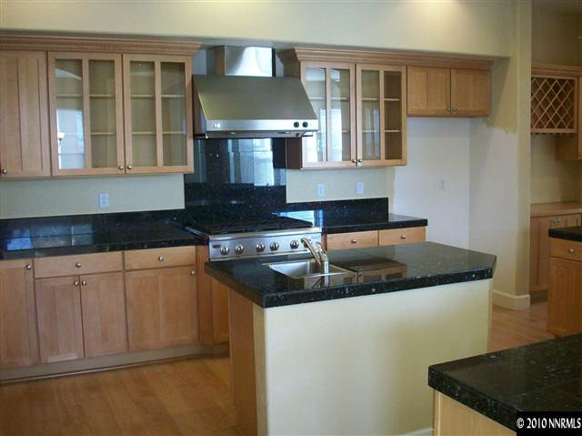 1696 Moquith Court Reno, NV 89521 - Photo 5 of 8 a kitchen with granite countertop a sink and a stove