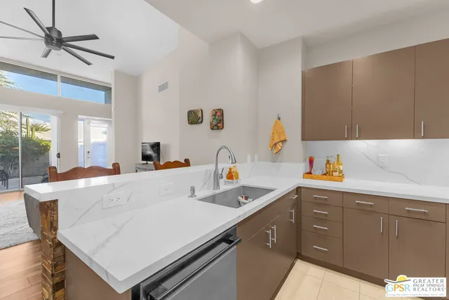 a kitchen with a sink a stove and cabinets