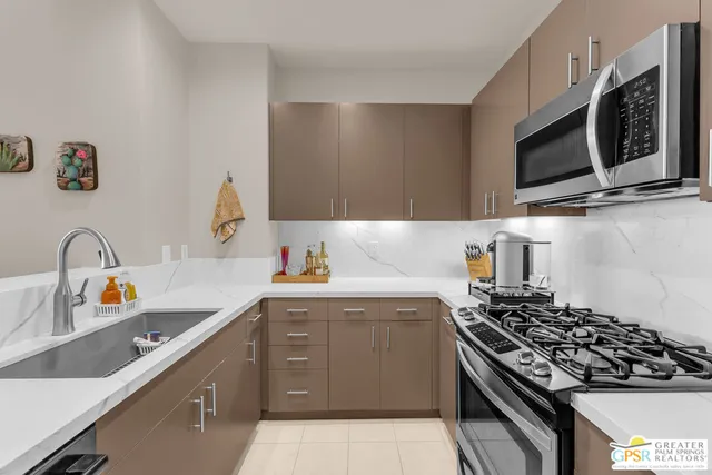 a kitchen with a sink stove and microwave