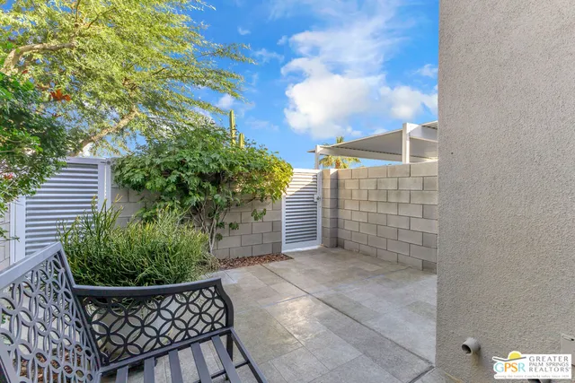 a view of a chair and table in the backyard