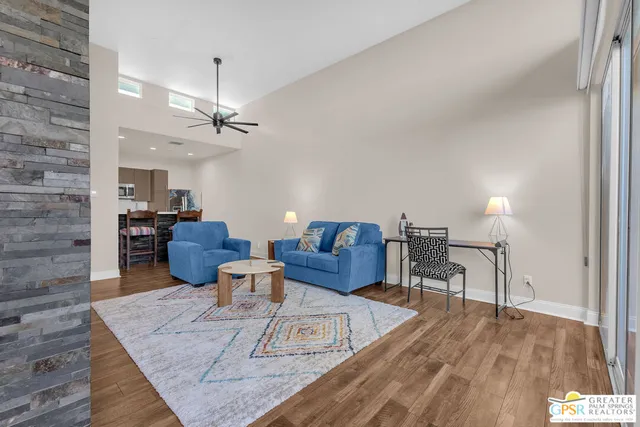 a living room with furniture and a wooden floor