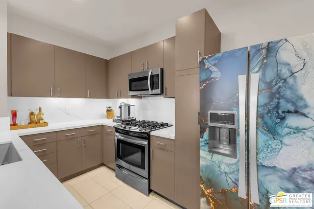 a kitchen with stainless steel appliances a stove sink and refrigerator