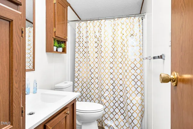 a bedroom with a bed and a mirror